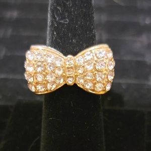 Beautiful gold colored ring with bling! with fake diamond bowtie Size 7
